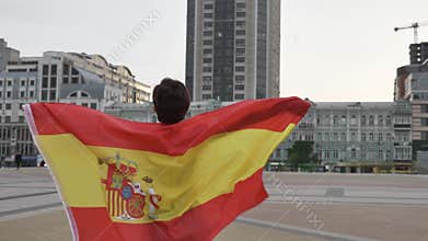 Young girl soccer fan holding a flag of Spain in the city, championship concept 50 fps