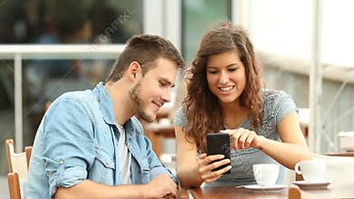 Couple talking about smart phone content