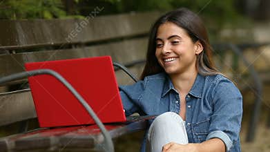 Woman browsing a laptop and laughing