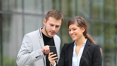 Businesspeople watching smart phone content