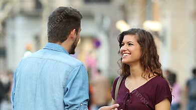 Woman and man talking in the street
