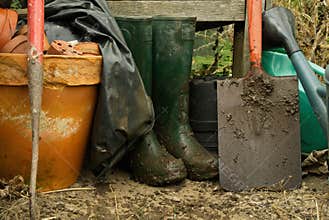 Muddy boots and spade.