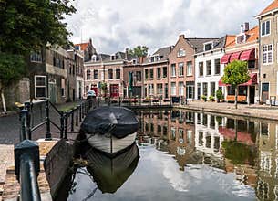 Traditional wooden sailing ships in water channel. Old historic harbor of Schiedam, The Netherlands