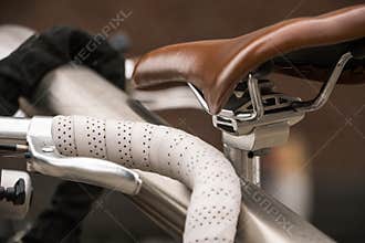 Bicycle luxury details. Parked Bicycles with Leather steering wheel at racing bike and Brown Leather bicycle saddle