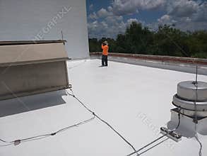 Roofer inspecting a commercial flat roof, EPDM Roofing