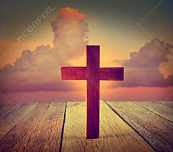 Christian wood cross on sunset sky
