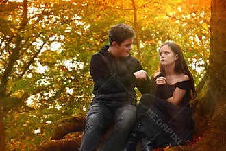 Friends enjoy a romantic mood in the autumn forest