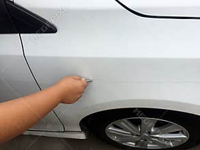 Scratch the car by the keys.