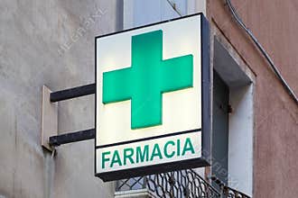 Pharmacy, farmacia sign with green cross in Italy