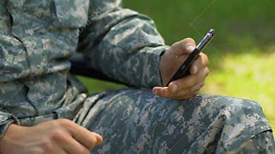 Army veteran scrolling web pages on smartphone, date service for disabled people