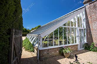Lean-to greenhouse. Beautiful English country walled garden brick-built glasshouse