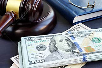 Litigation finance. Gavel and dollar banknotes. Bail bonds.