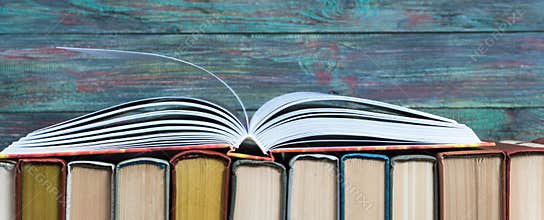 Open book hardback on Stack books