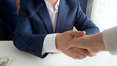 Closeup 4k footage of person giving money as bribe while shaking hand to corrupted politician