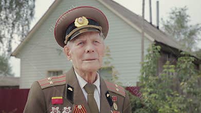 Portrait of an elderly, gray-haired veteran of world war II and world war II in military uniform