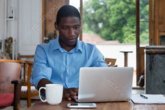 Hard working african american man with laptop