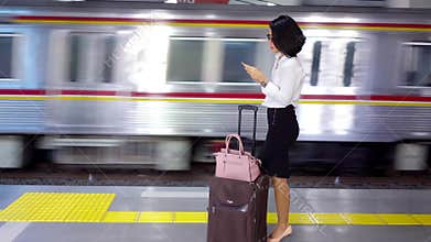 Business woman standing on station platform