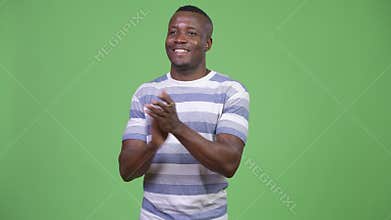 Young happy African man clapping hands