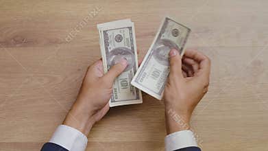 Top view of male hands counting money and giving bribe