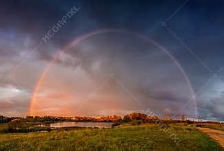Rainbow landscape and dramatic rain sky
