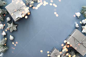 Christmas silver handmade gift boxes on blue background top view. Merry Christmas greeting card, frame. Winter xmas holiday theme.