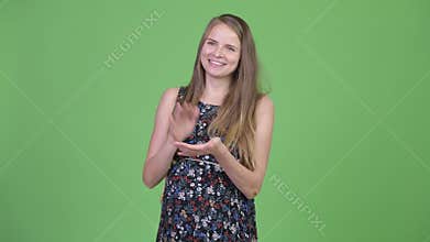 Young happy pregnant woman thinking while clapping hands