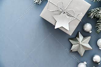 Christmas silver handmade gift boxes on blue background top view. Merry Christmas greeting card, frame. Winter xmas holiday theme.