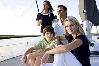 Family with teenage children sitting on boat