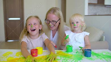 Happy family paints colors. Happy family paints colors. Mother and daughter having fun and paint each other`s on faces