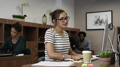 Young casaul woman working with creative team