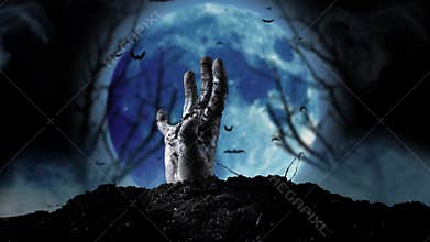 Human hand rises from the ground can be seen the blue moon and tree silhouettes. Smoky background