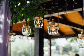 Light bulb decor in outdoor wedding ceremony