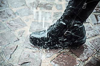 leather boot in the rain on the cobblestone