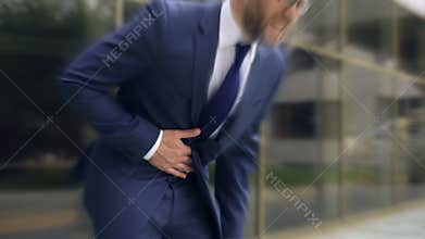 Businessman suffers from sharp stomach ache, gastritis, heartburn, dizzy effect