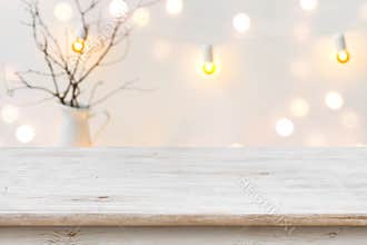 Wooden table in front of blurred abstract winter holiday background