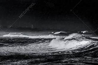 Storm, rain and waves on the beach