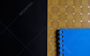 Education and productivity concept. blue books, brown wooden on black background