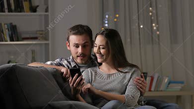 Excited couple finding amazing phone content