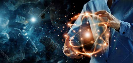 Abstract science, hands holding atomic particle, nuclear energy