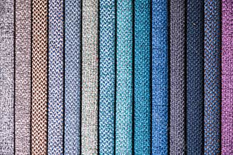 Colorful and bright fabric samples of furniture and clothing upholstery. Close-up of a palette of textile abstract