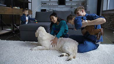 Happy diverse family resting with children and dog