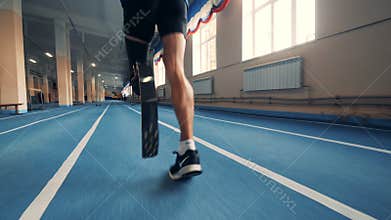 Nizhny Novgorod, Russia - CIRCA November 2018: Gym track and an athlete with a prosthetic leg running along it
