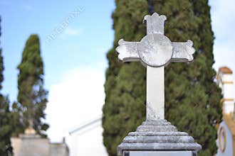 White stone cross in a cemetery