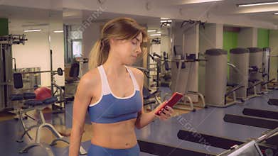 Sportswoman warming up walk texting on mobile phone