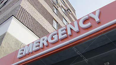 Tilt up view of main entrance of sign of emergency service with inscription, white letters