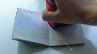 Visa denied, customs officer hand stamping seal in passport, travelling abroad
