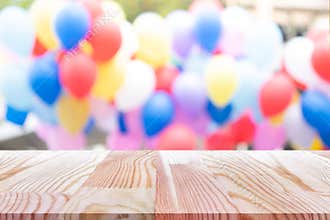 Emtry wooden table on top over blur balloon background, can be used mock up for montage products display or design layout