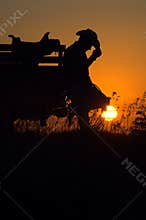 Resting cowboy at end of day sunset