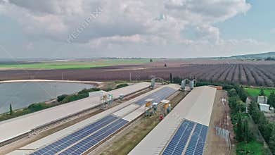 Aerial footage over chicken farm covered with solar panels in northern Israel