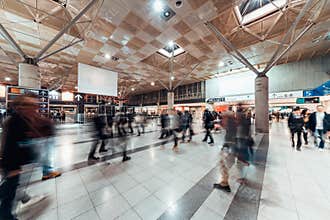 Motion blur of people walking in public exhibition hall. Business tradeshow, job fair, or commercial activity concept